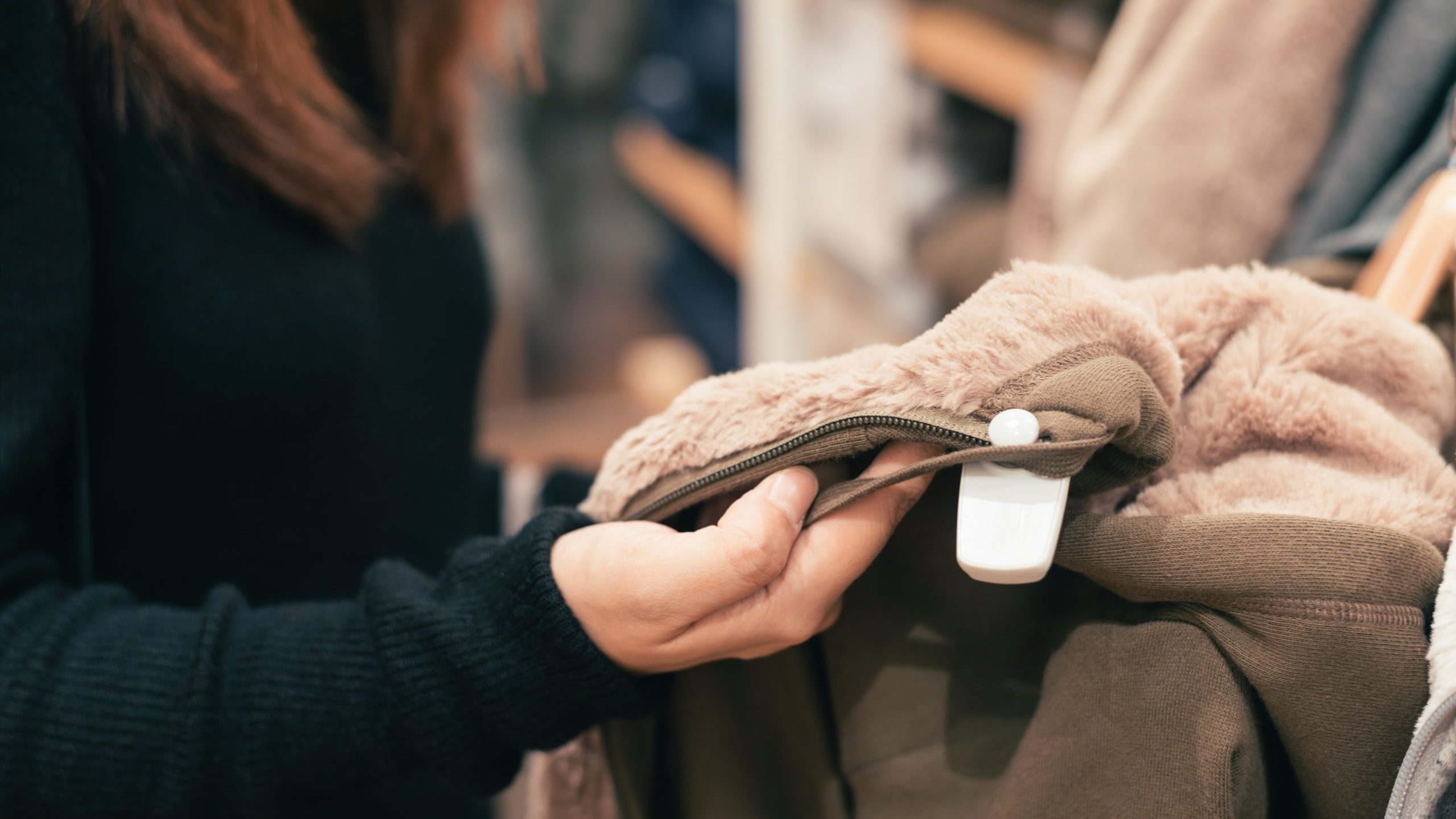 woman-wearing-black-sweater-holding-fleece-cloth-733850